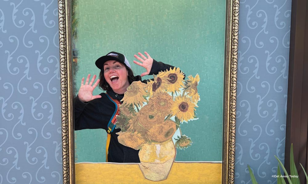 Woman posing in a Van Gogh Photo Op Frame