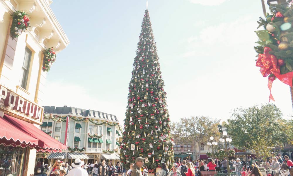 Tall tree on Main street at Disneyland decorated with red ornaments