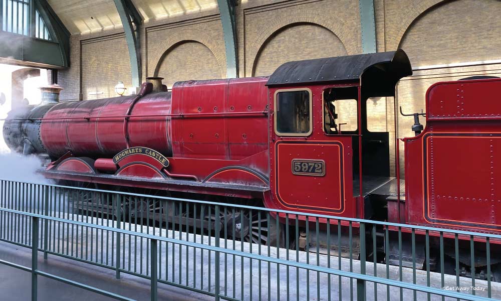 Hogwarts Express Train with smoke towards the engine in the station