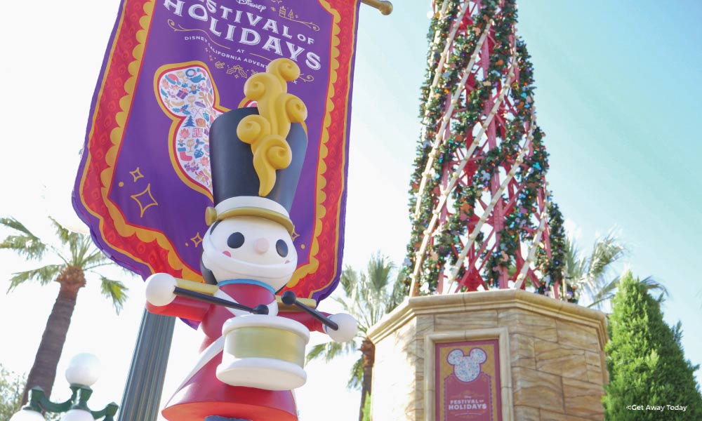 Outdoor Festival of Holidays sign with giant wooden toy solider and christmas tree