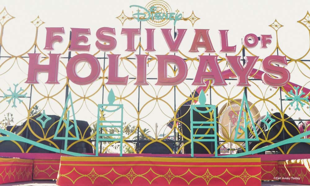 Light up sign for Festivals of Holidays behind a stage for performing