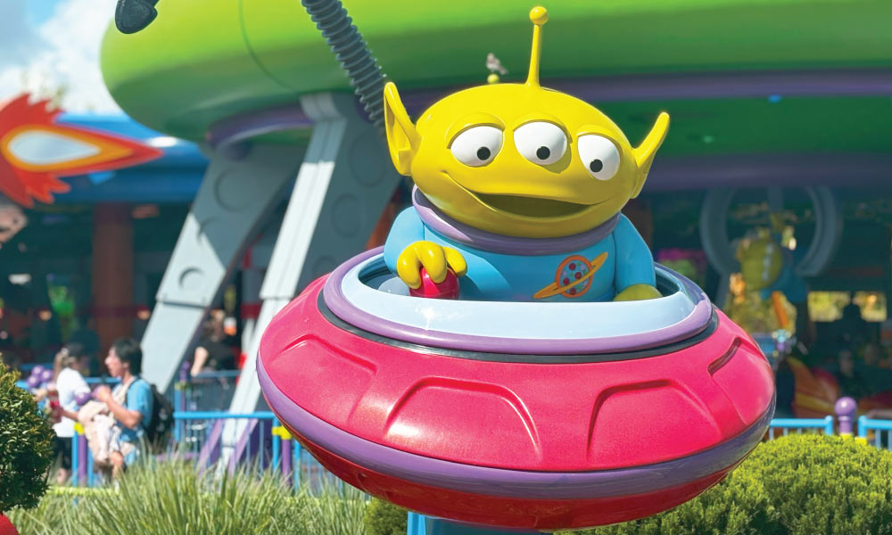 LGM Alien outisde of Swirling Saucers at Disney World