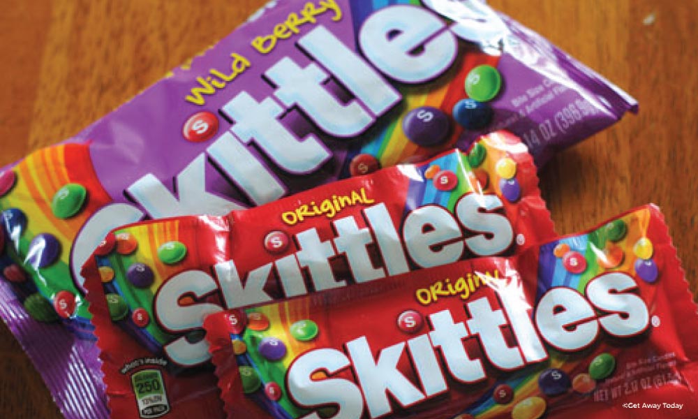 two bags of orignal skittles and one larger bag of wild berry skittles