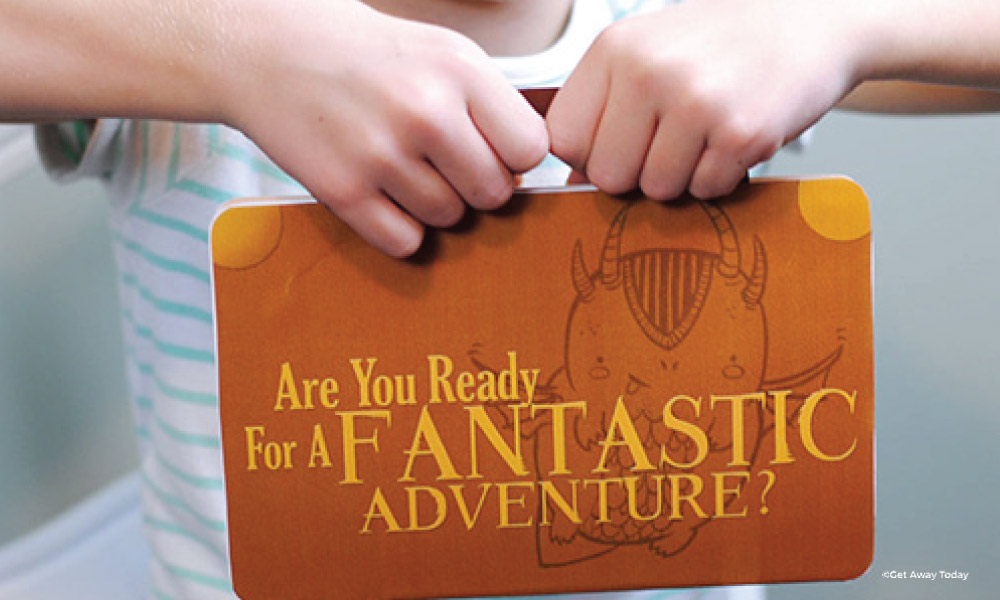 Paper suitcase with Fantastic Beasts held by a child