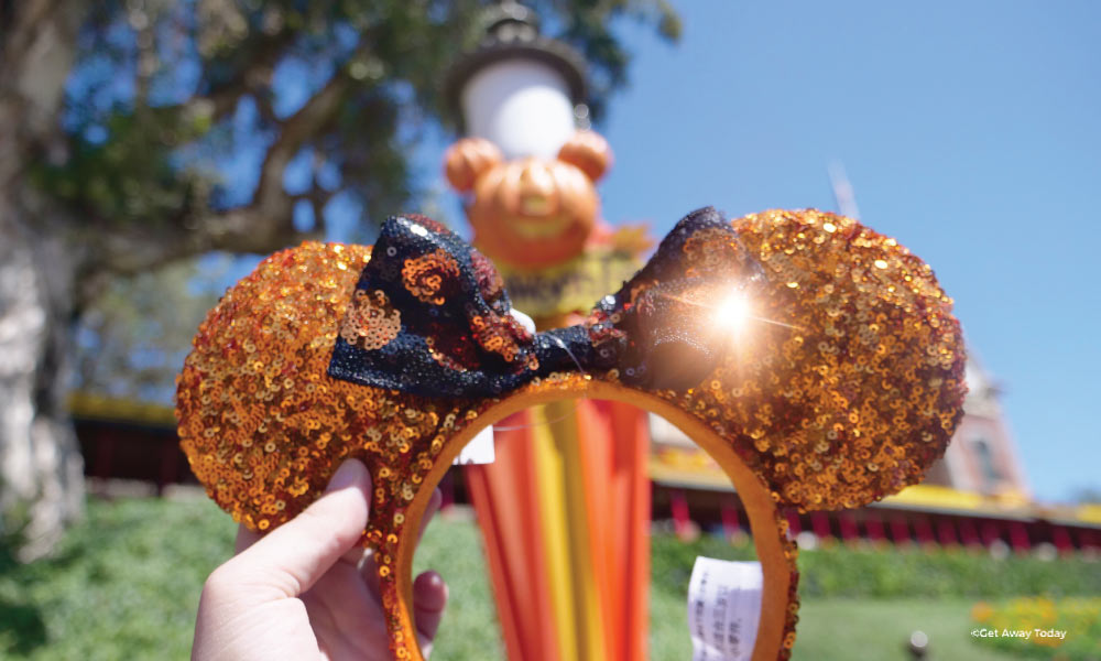 Orange and black halloween minnie ears at Disneyland reflecting the sun