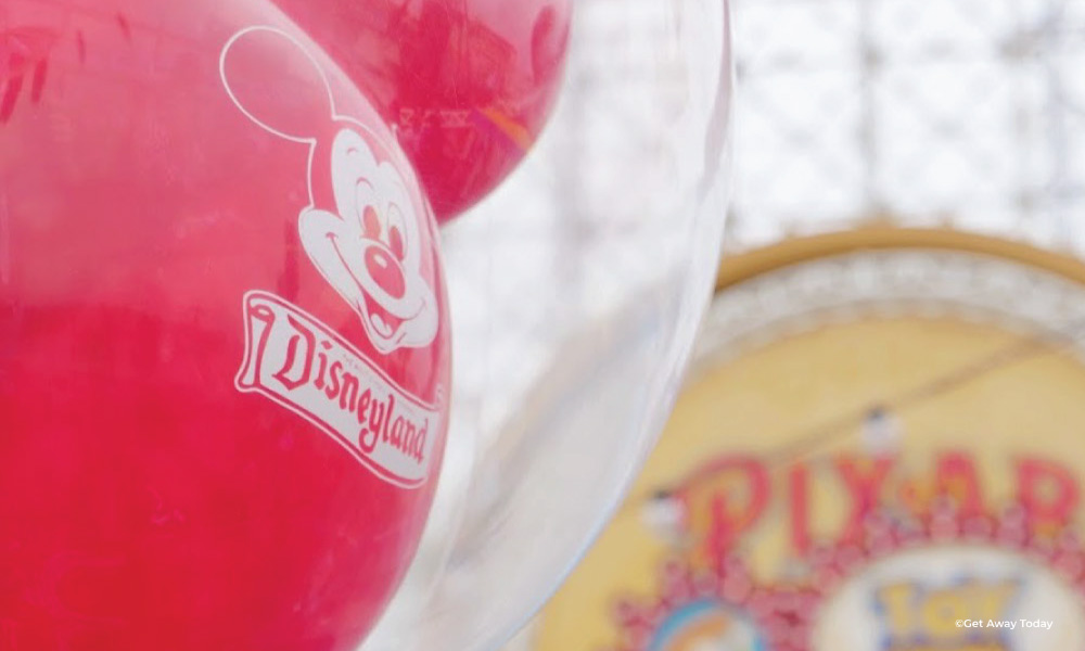 Red Disneyland Mickey Balloon with Pixar Pier in the Background