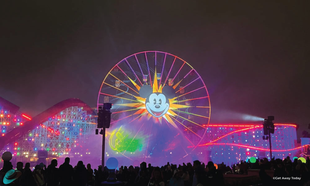 World of Color at Disneyland with the ferris wheel lit up