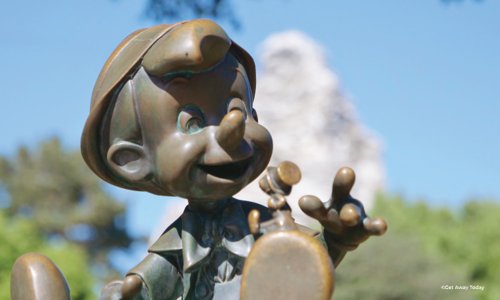 Statue of Pinnochio at Disneyland in front of the Matterhorn