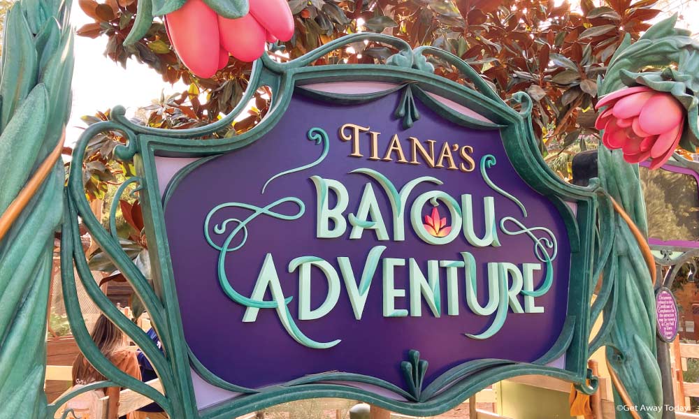 Purple sign with flowers for Tiana's Bayou Adventure