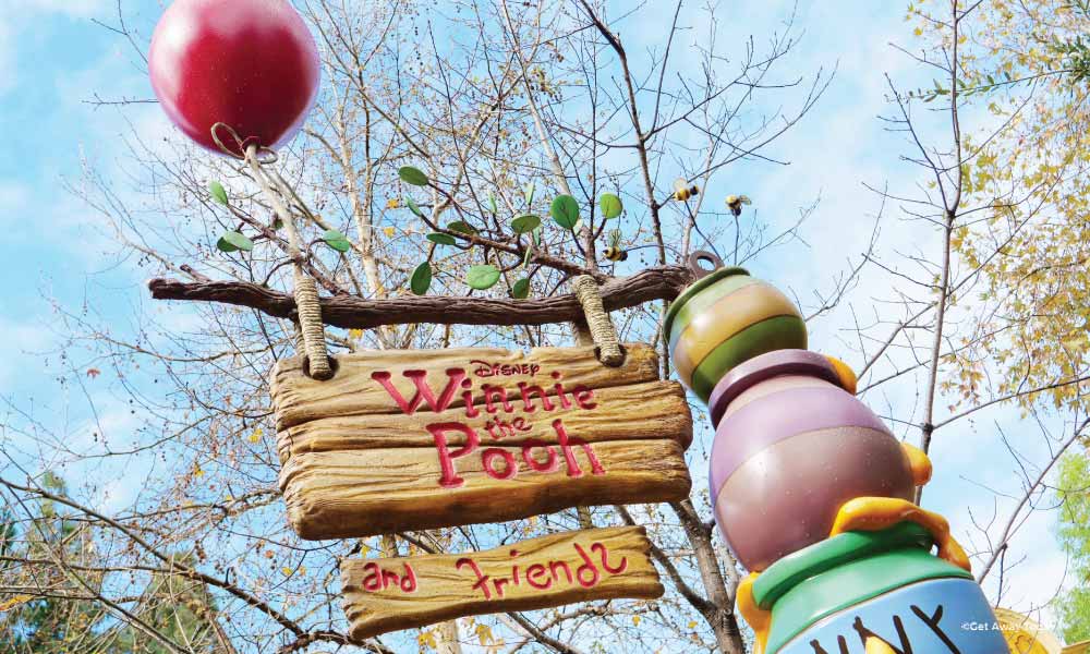 Wooden Sign to Winnie the Pooh and Friends with honey pots and a red balloon