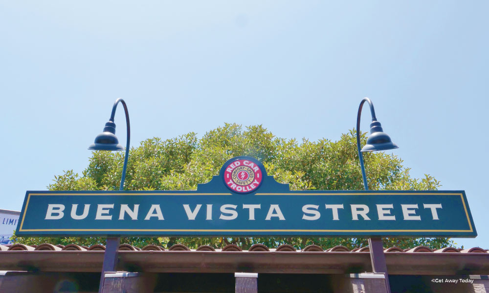 Sign with light poles that says "Buena Vista Street"