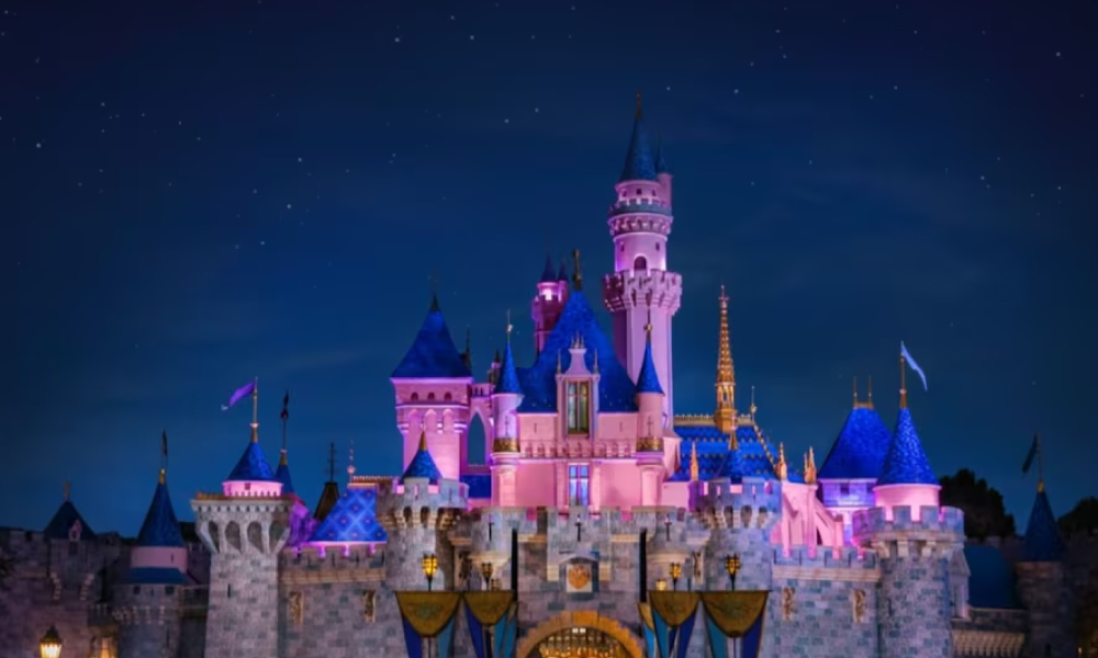 Sleeping Beauty Castle lit up at night at Disneyland 