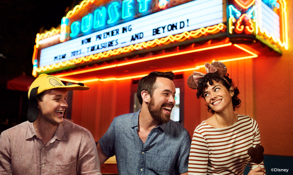 Friends laughing in front of the Sunset Theater in Disney World