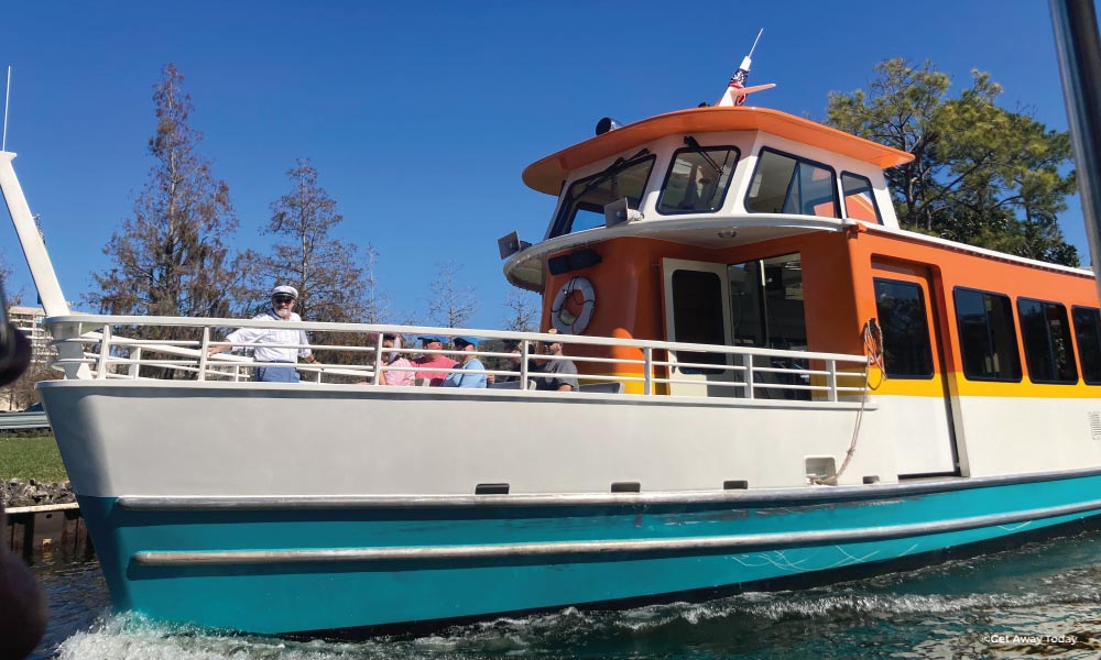 Orange, Yellow, White, Blue striped boat at Disney World