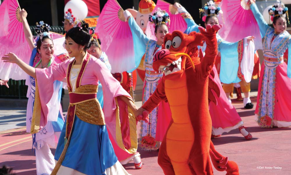 Mushu and Mulan waving during a Parade at California Adventure