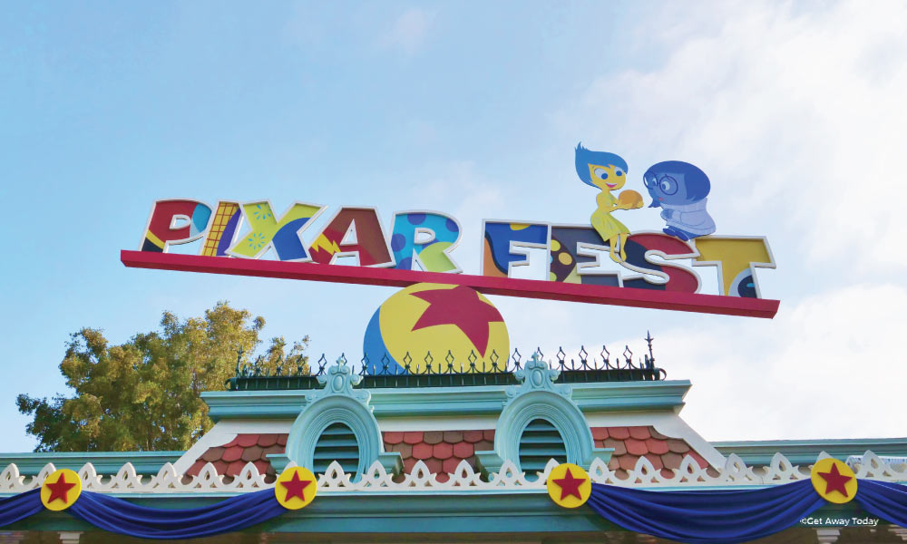 Pixar Fest Sign above entrance gate featuring Joy and Sadness