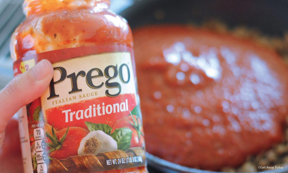 Empty jar of Prego Traditional Spaghetti Sauce poured over sausage