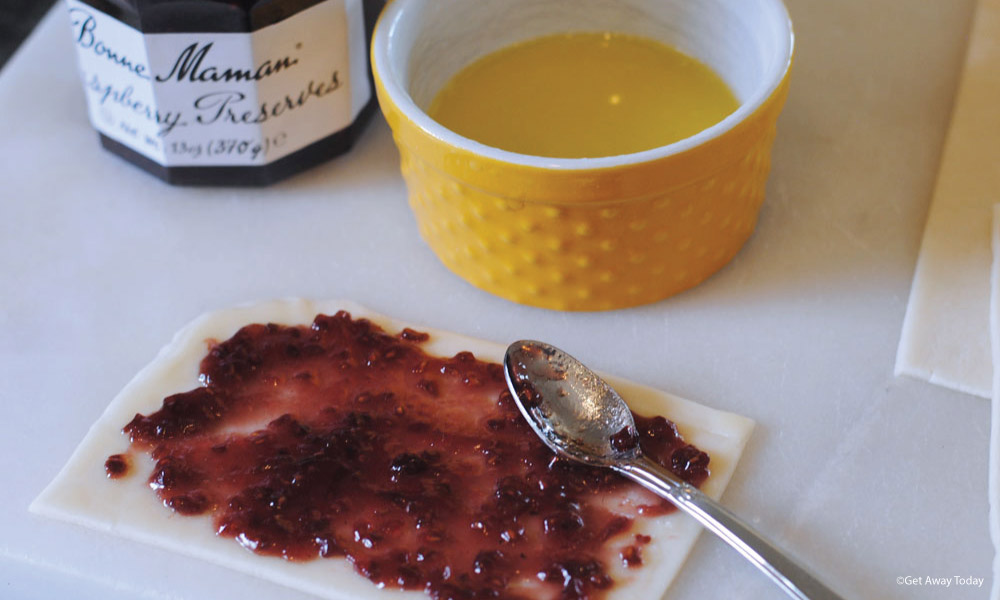 Jam spread over unbaked pie dough