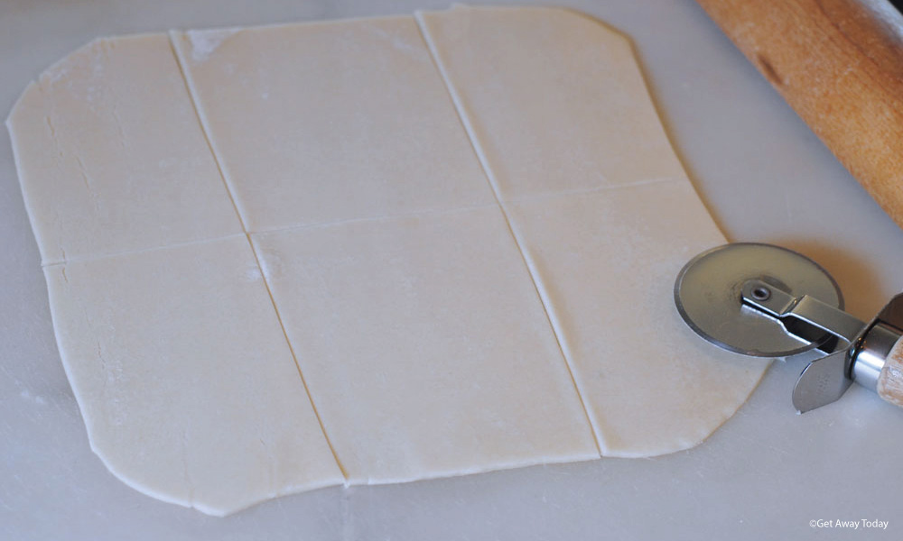 Rolled out pie dough cut into 6 rectanges with a pizza cutter