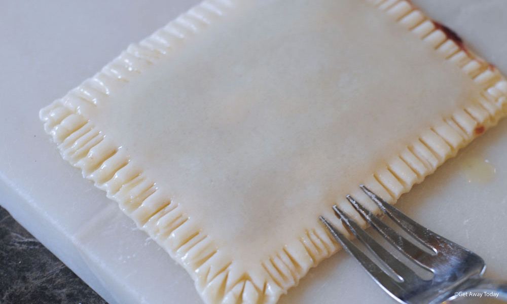 homemade pop tart edges getting pinched together with a fork