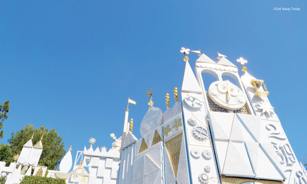 it's a small world at disneyland with gold leafing on the exterior