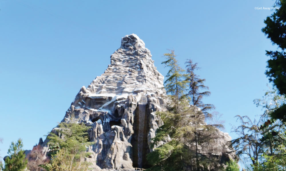 Matterhorn ride at Disneyland surrounded by trees