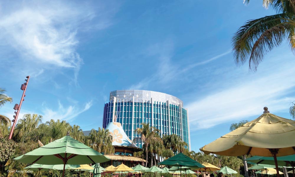 Cabana Bay Exterior in the distance with sun shade umbrellas