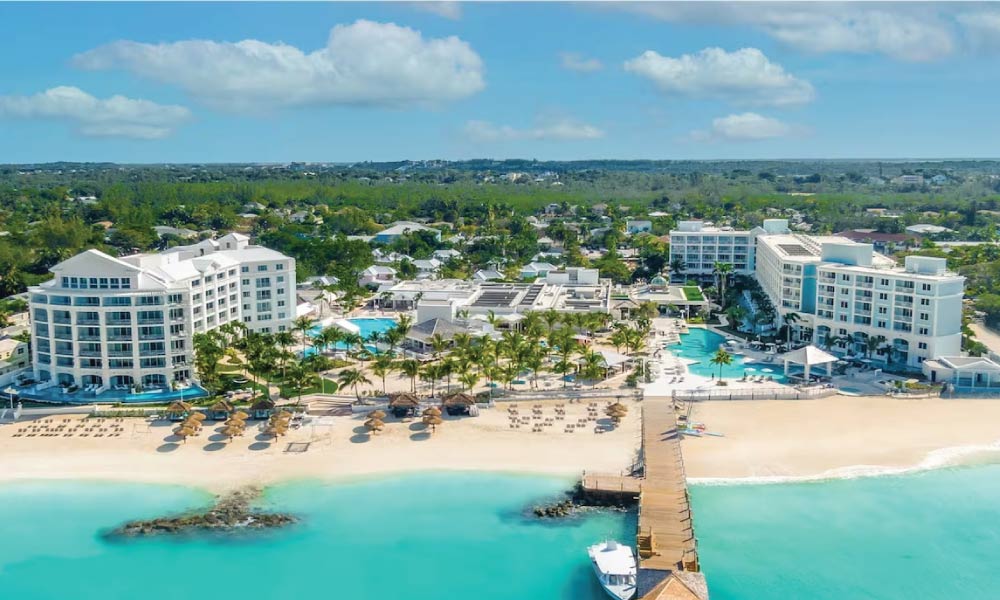 Aerial view of Sandals resort surrounded by bright blue ocean with a white exterior