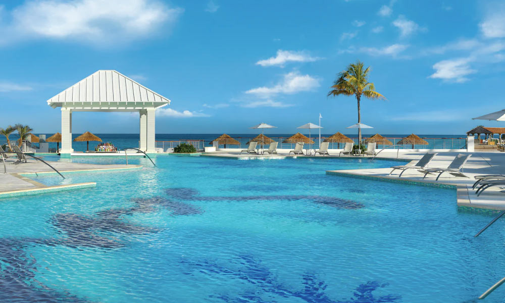 Pool with beach chairs and cabanas