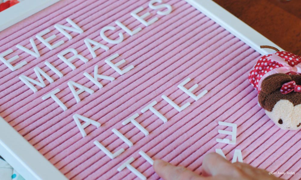 placing letters on a pink letter board