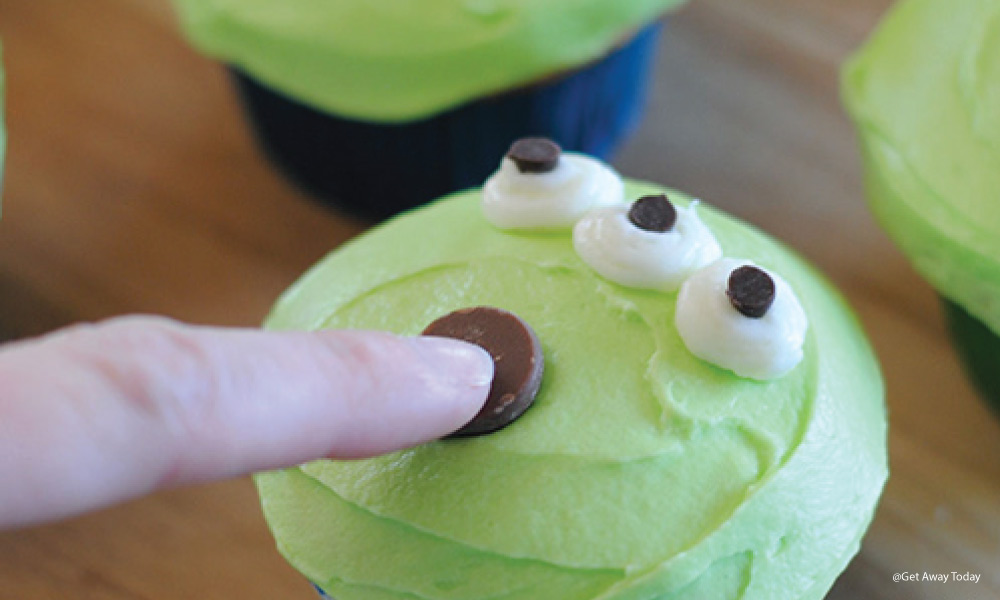 large chocolate chip added to an alien cupcake for its mouth