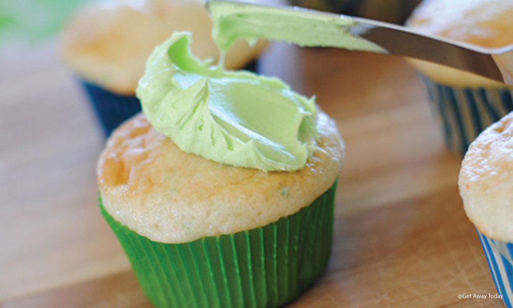 cupcake getting frosted with green frosting