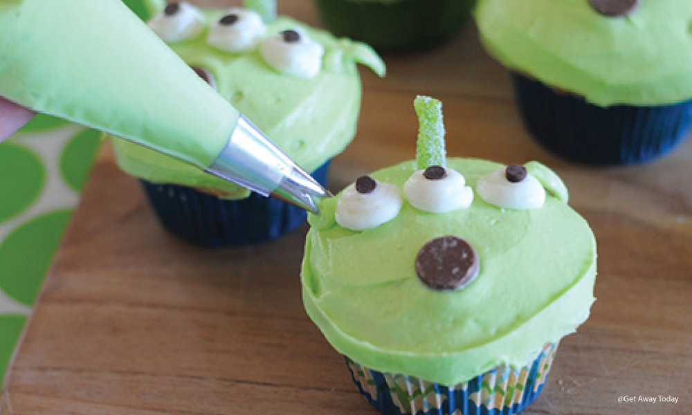 adding frosting ears to a toy story alien cupcake