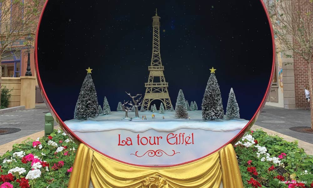 Decor resembling a giant snow globe with the Eiffel Tower and Christmas trees