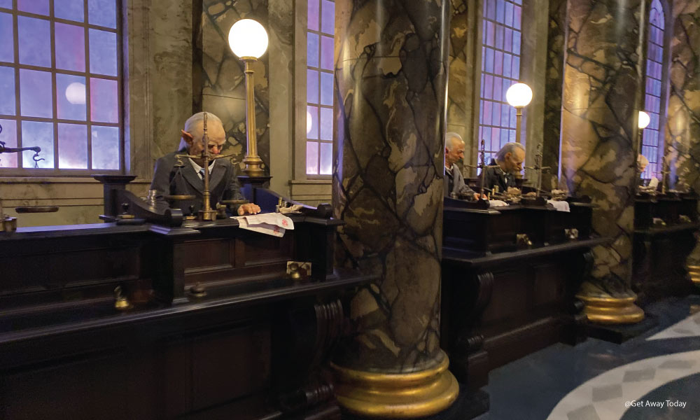 Goblin tellers working at Gringotts bank in a marble lobby