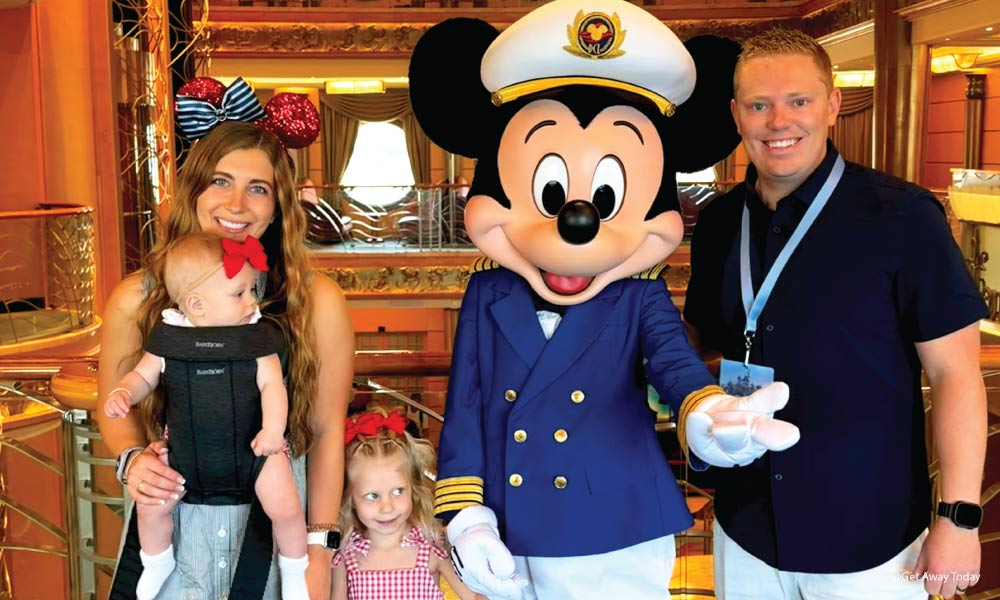 family posing with mickey on disney wonder
